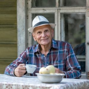 Elderly man at home eating ice crream