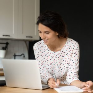 Woman at computer researching Medicare plans